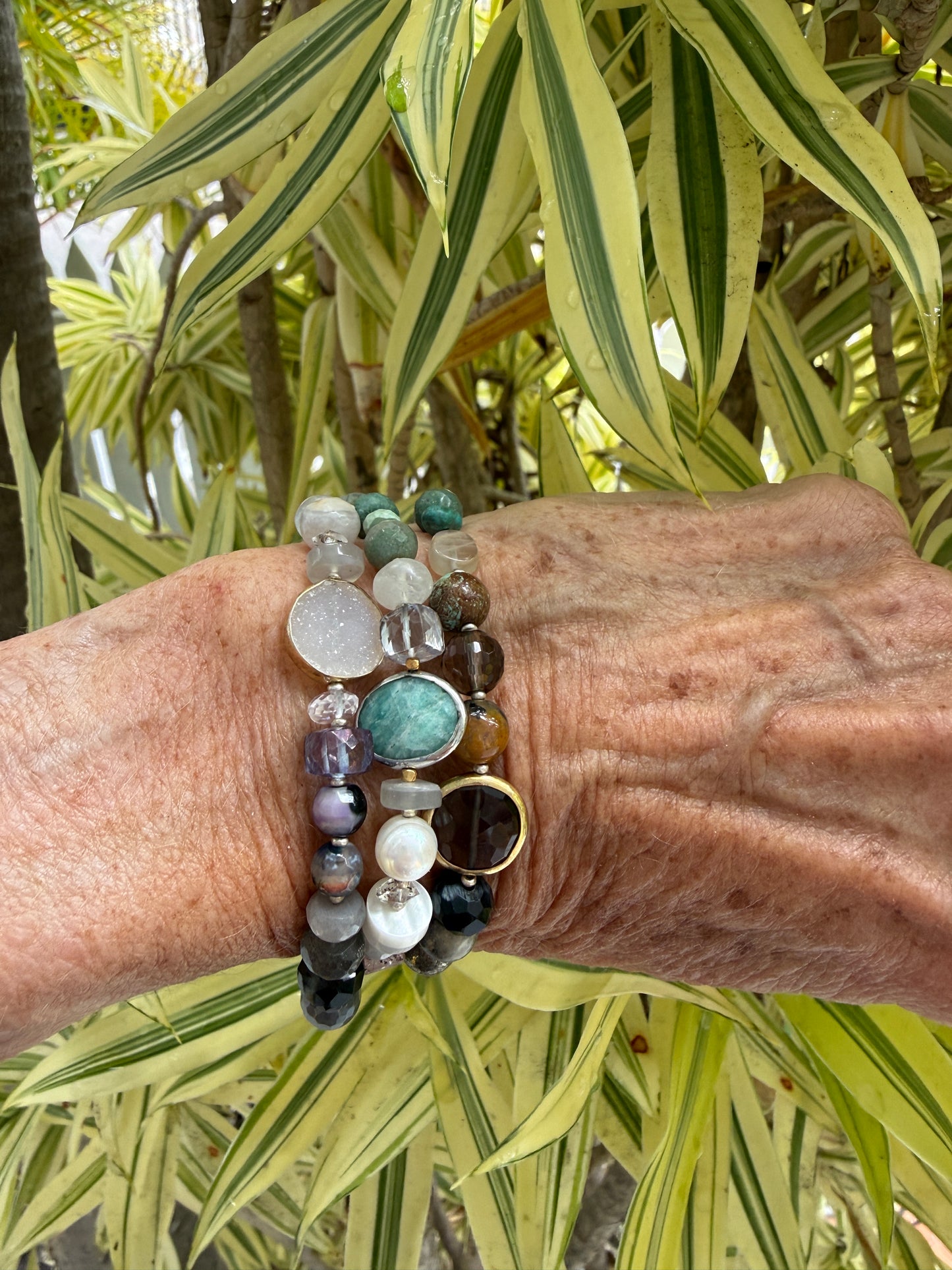 Assorted gemstones with smoky quartz focal bracelet. Sterling clasp and extender chain. 7-8.25”