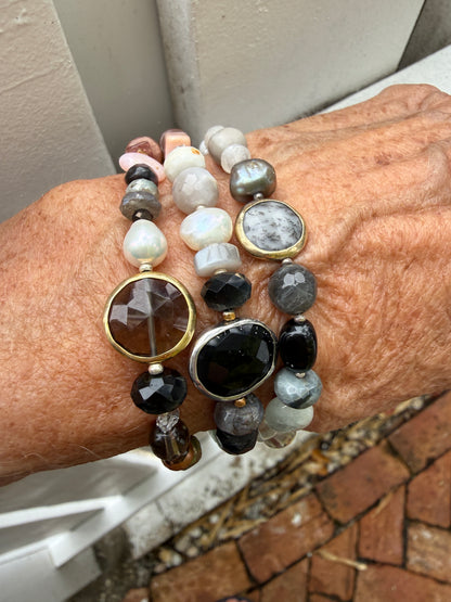 Mixed gemstone bracelet with black onyx focal bead and sterling clasp and extender chain. 6-7”