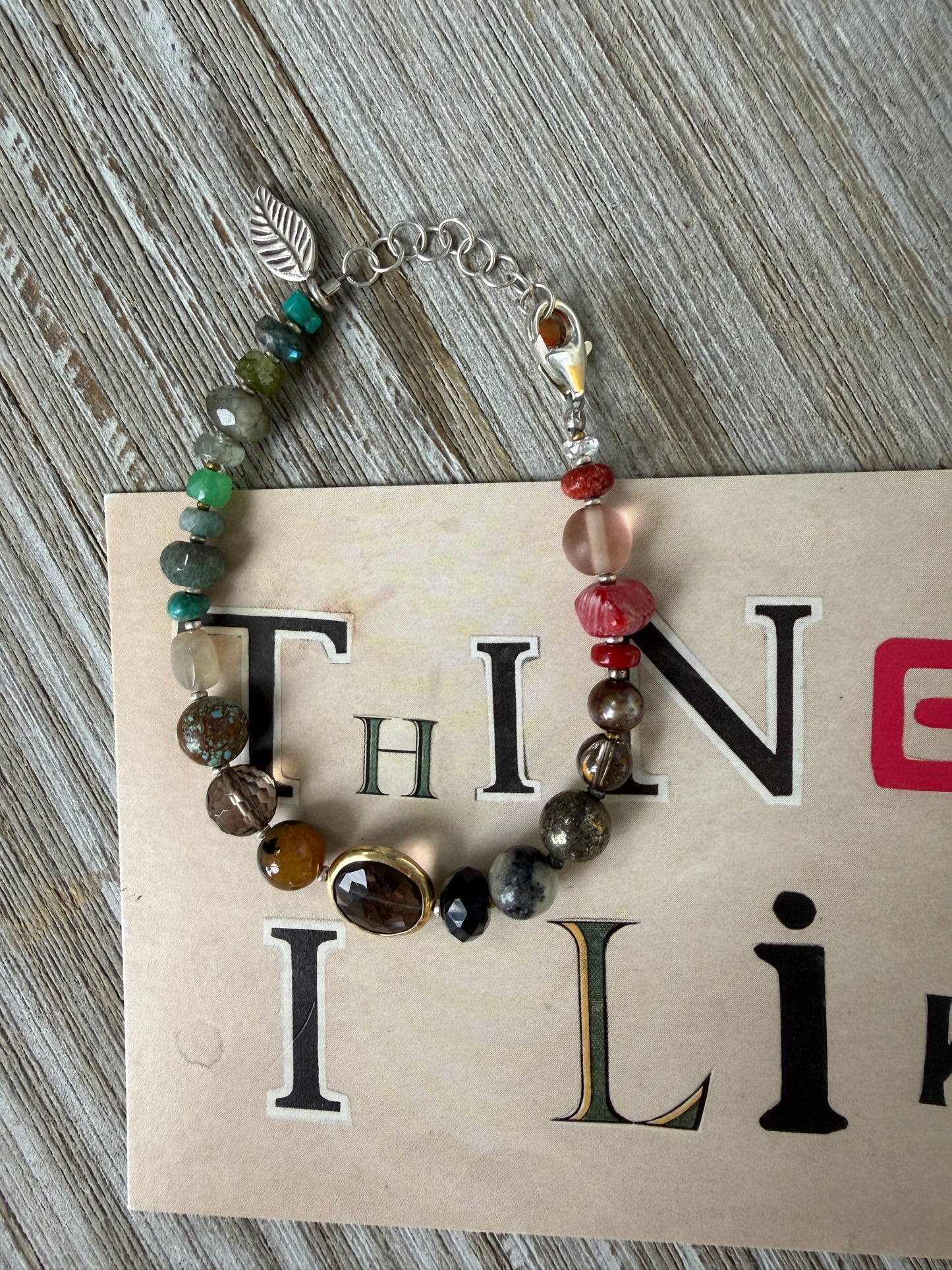 Assorted gemstones with smoky quartz focal bracelet. Sterling clasp and extender chain. 7-8.25”