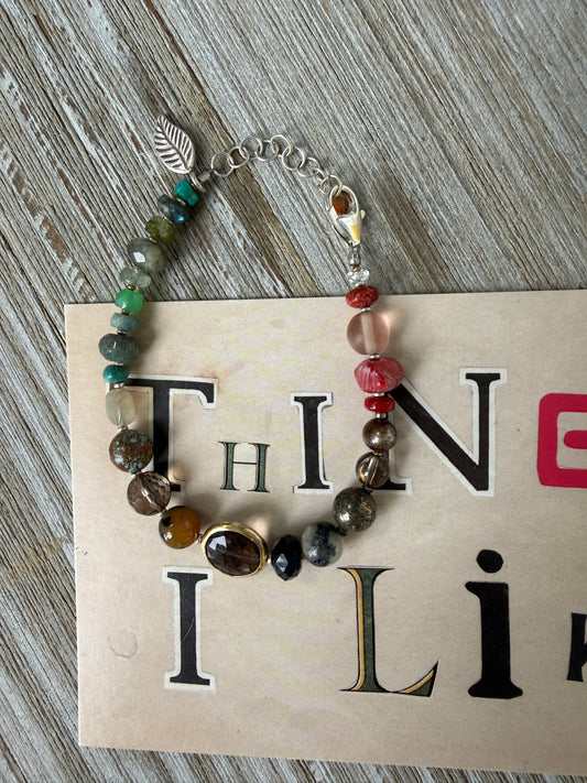 Assorted gemstones with smoky quartz focal bracelet. Sterling clasp and extender chain. 7-8.25”