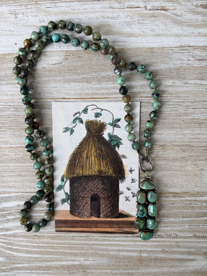 Green turquoise knotted necklace with Tibetan turquoise (removable) pendant. 34.25”.