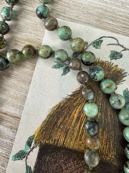 Green turquoise knotted necklace with Tibetan turquoise (removable) pendant. 34.25”.