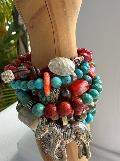 Coral beads connected by a fine silver hammered button and leather loop. 6.5”