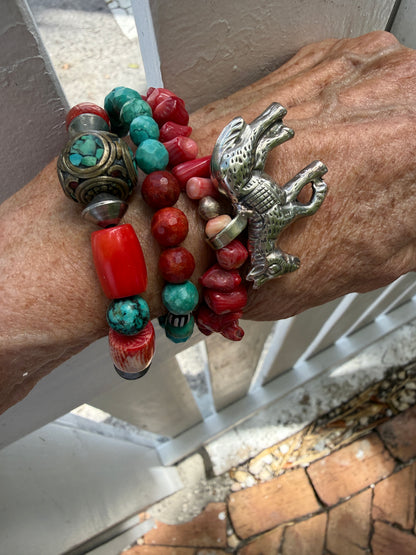 Old Tibetan bead with turquoise inlay surrounded by coral and turquoise beads stretch bracelet. 7”