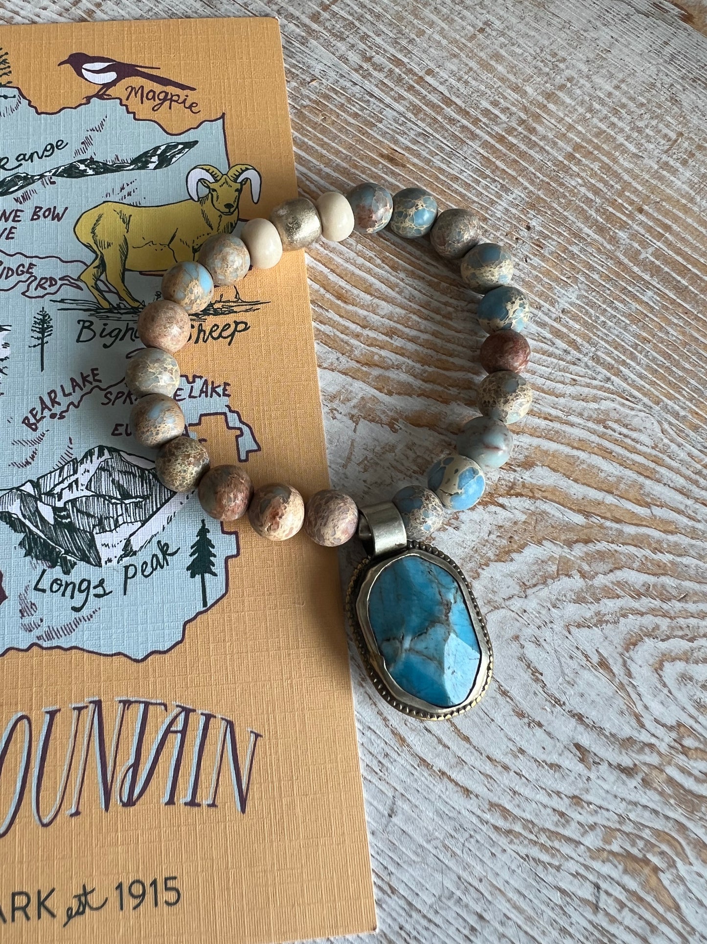 Tibetan turquoise pendant surrounded by sea sediment Jasper. Stretch bracelet 6.5” (small wrist).