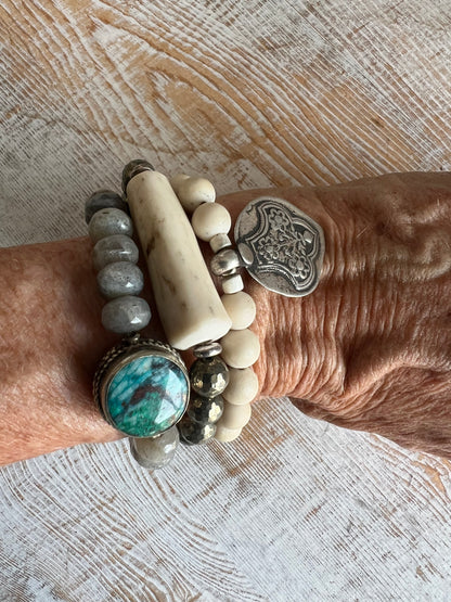 Old Tibetan sterling silver talisman on riverstone beads. Stack bracelet. 6-6.5”