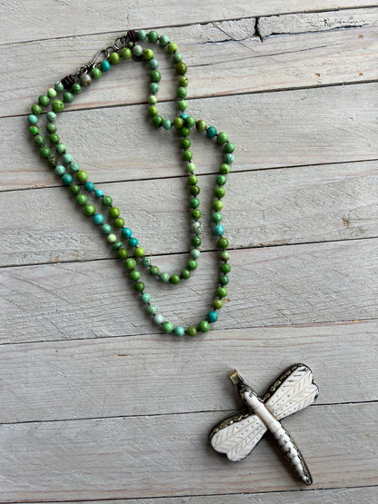 Tibetan carved bone dragonfly pendant on green and blue turquoise. Long, knotted necklace.