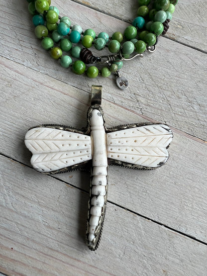 Tibetan carved bone dragonfly pendant on green and blue turquoise. Long, knotted necklace.