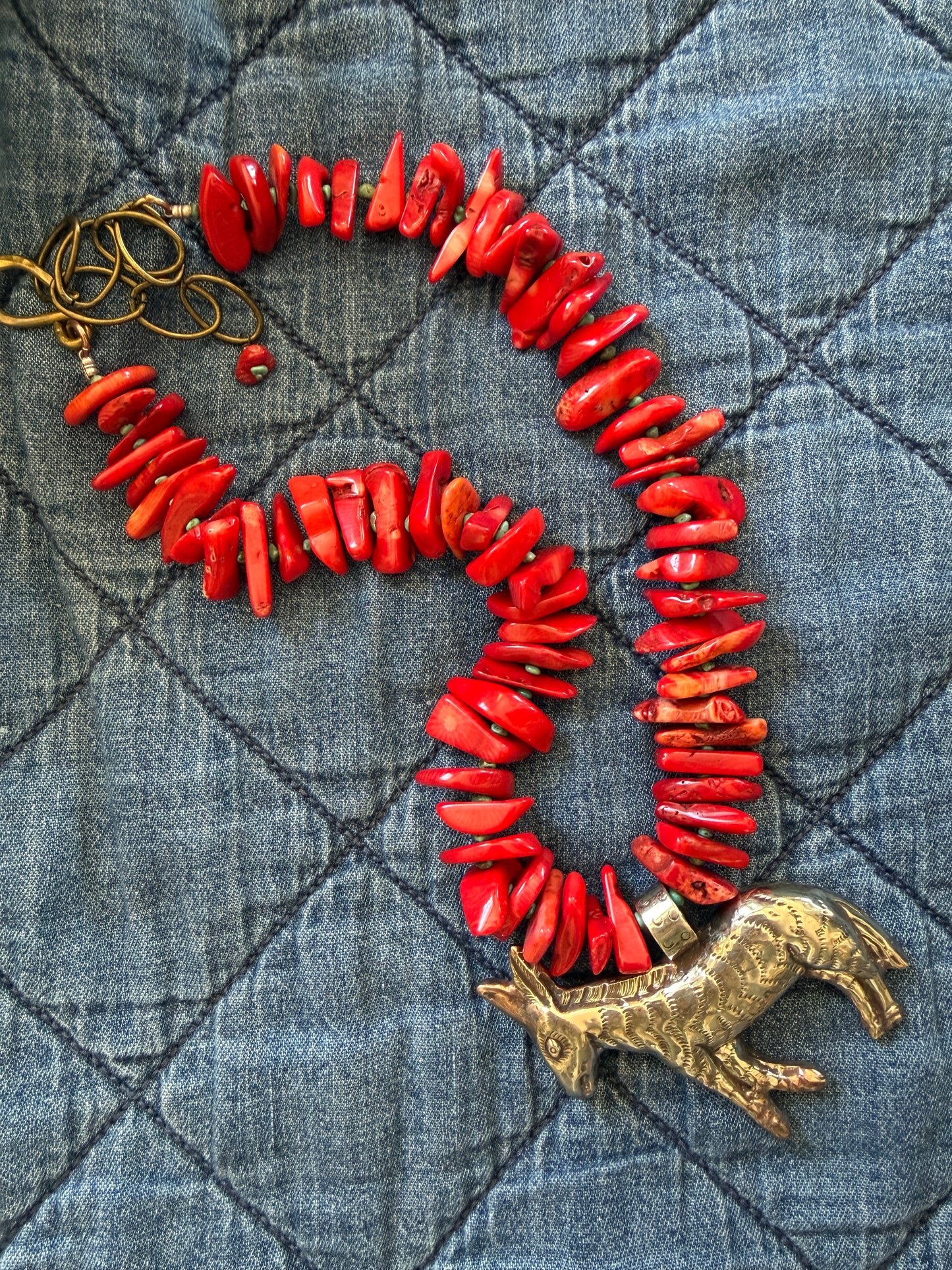 Fun red broom coral and turquoise necklace with donkey pendant. 18.5-23”