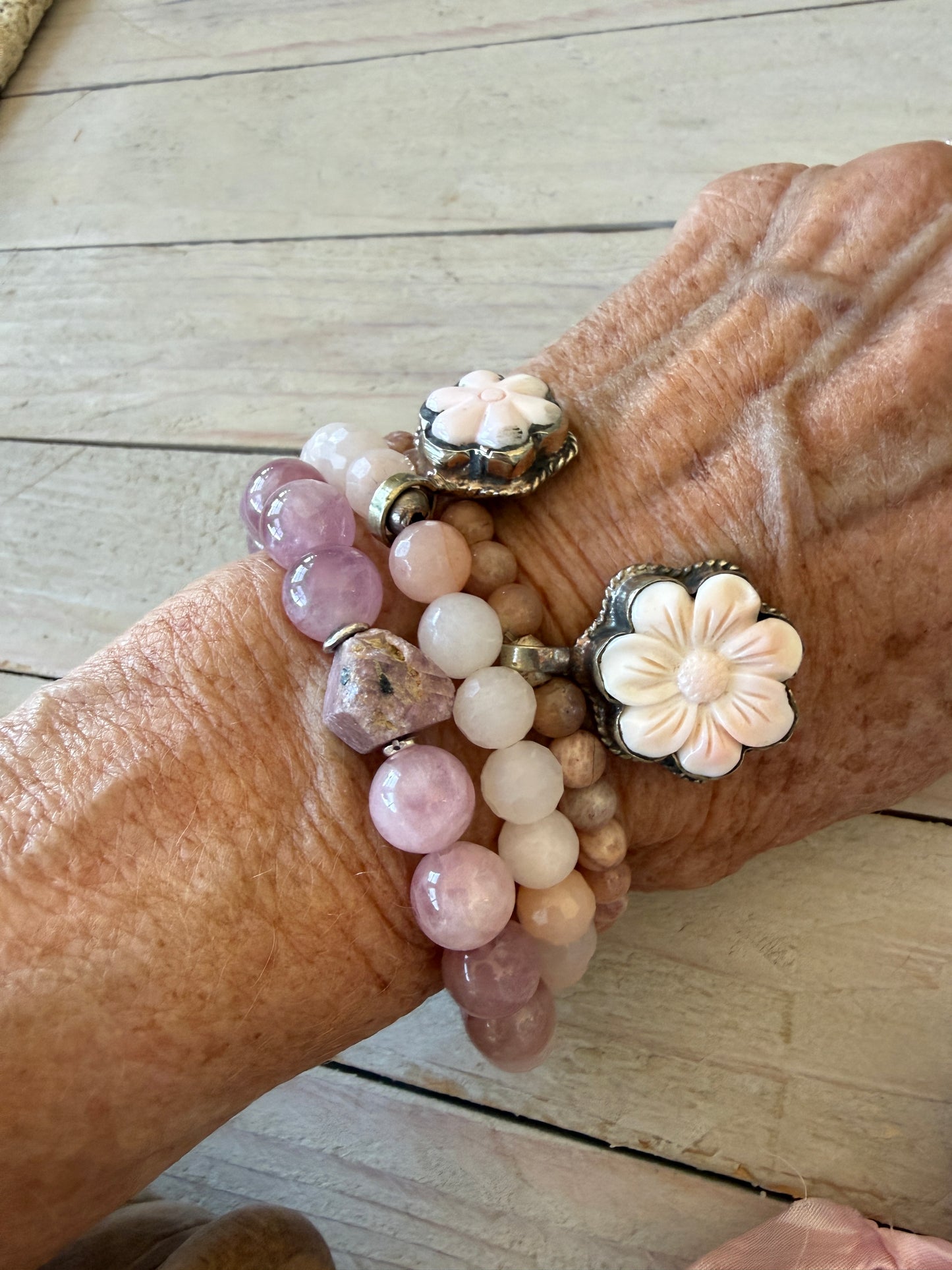 A rough cut, unpolished ruby sits among rose quartz beads in this pink stretch bracelet. 7.5”