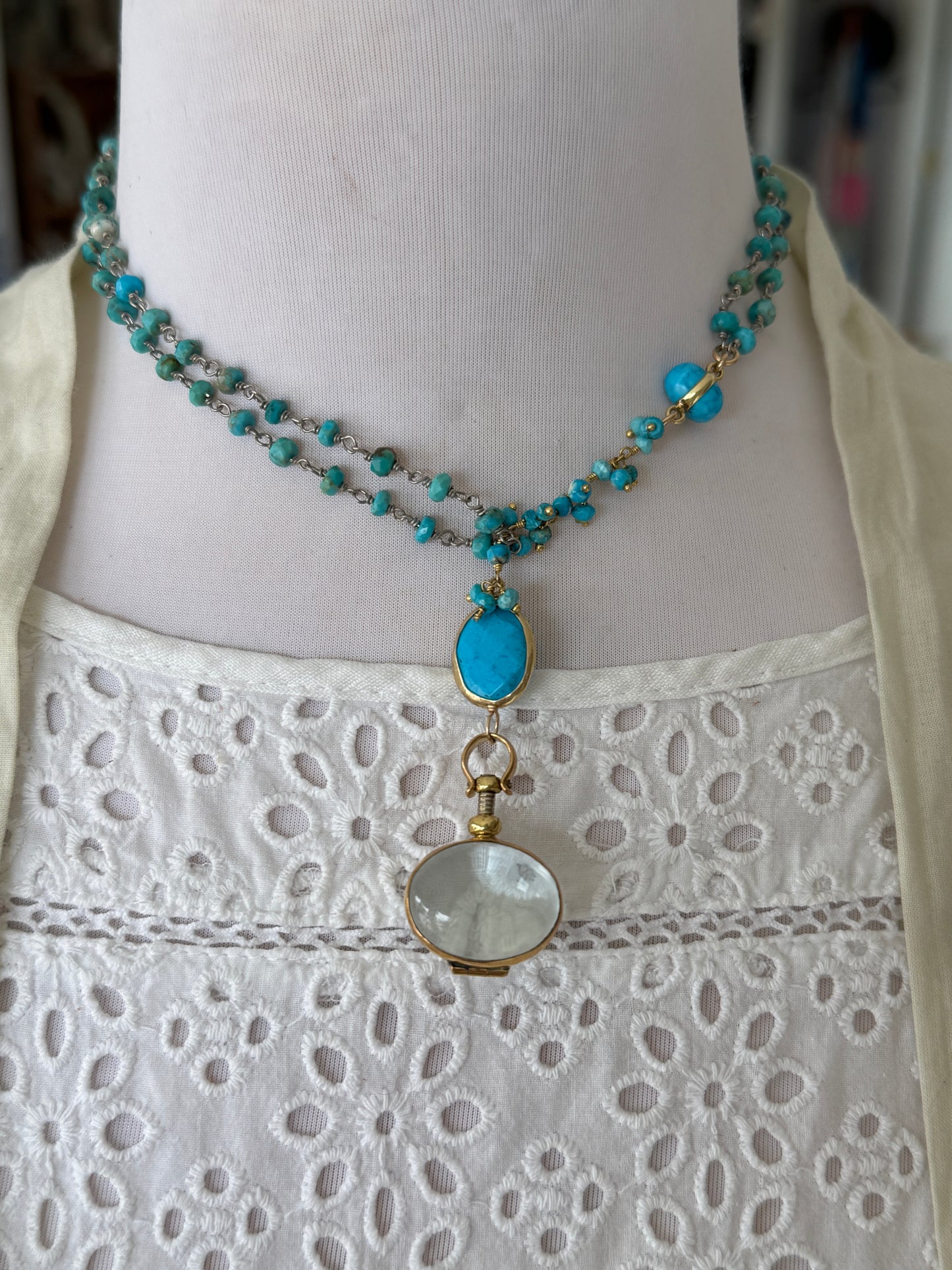 Turquoise rosary style chain with turquoise and gold accent pieces and brass locket necklace.