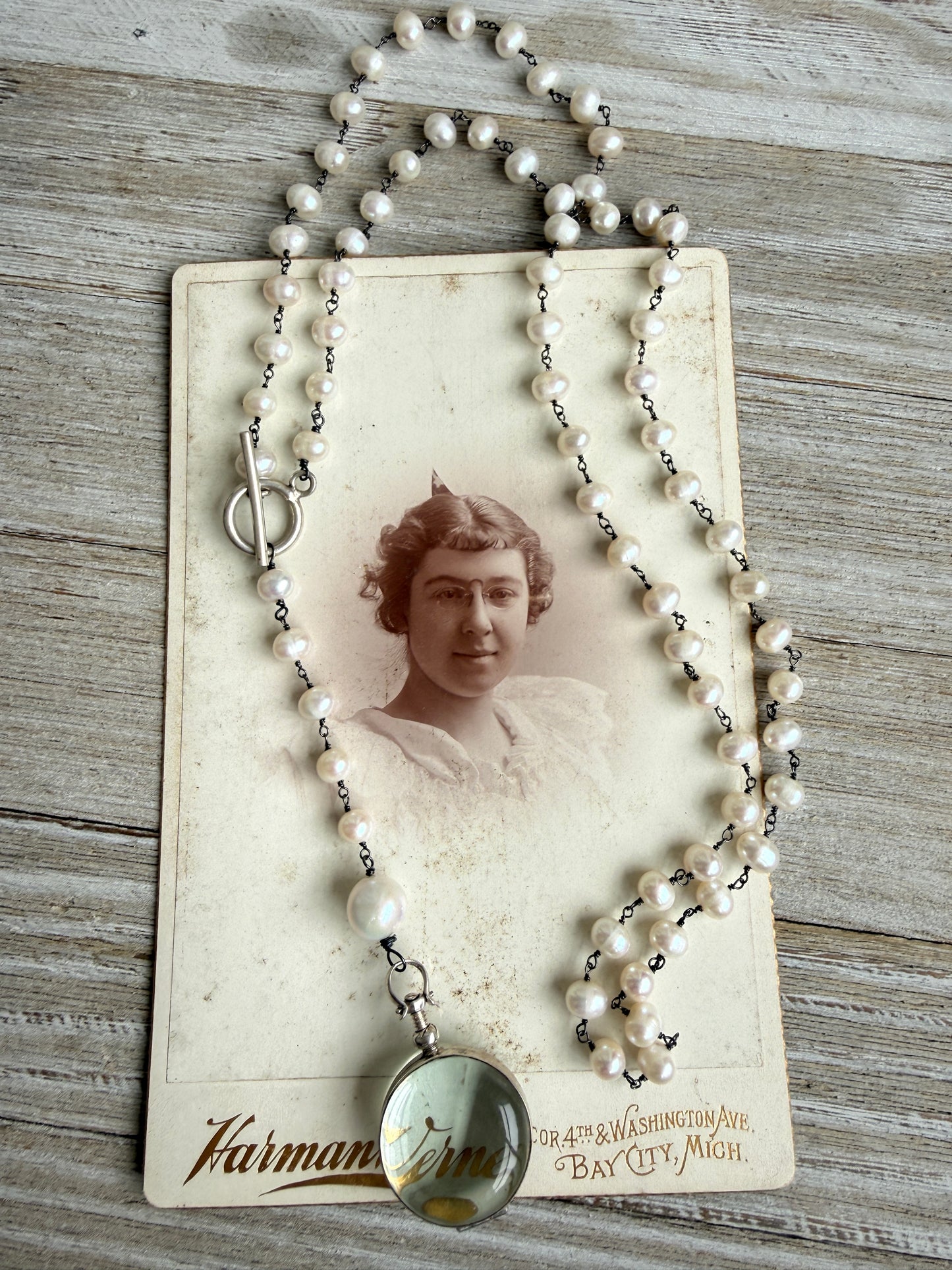 Pearl and sterling locket Y necklace.
