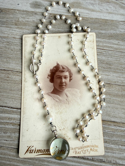 Pearl and sterling locket Y necklace.