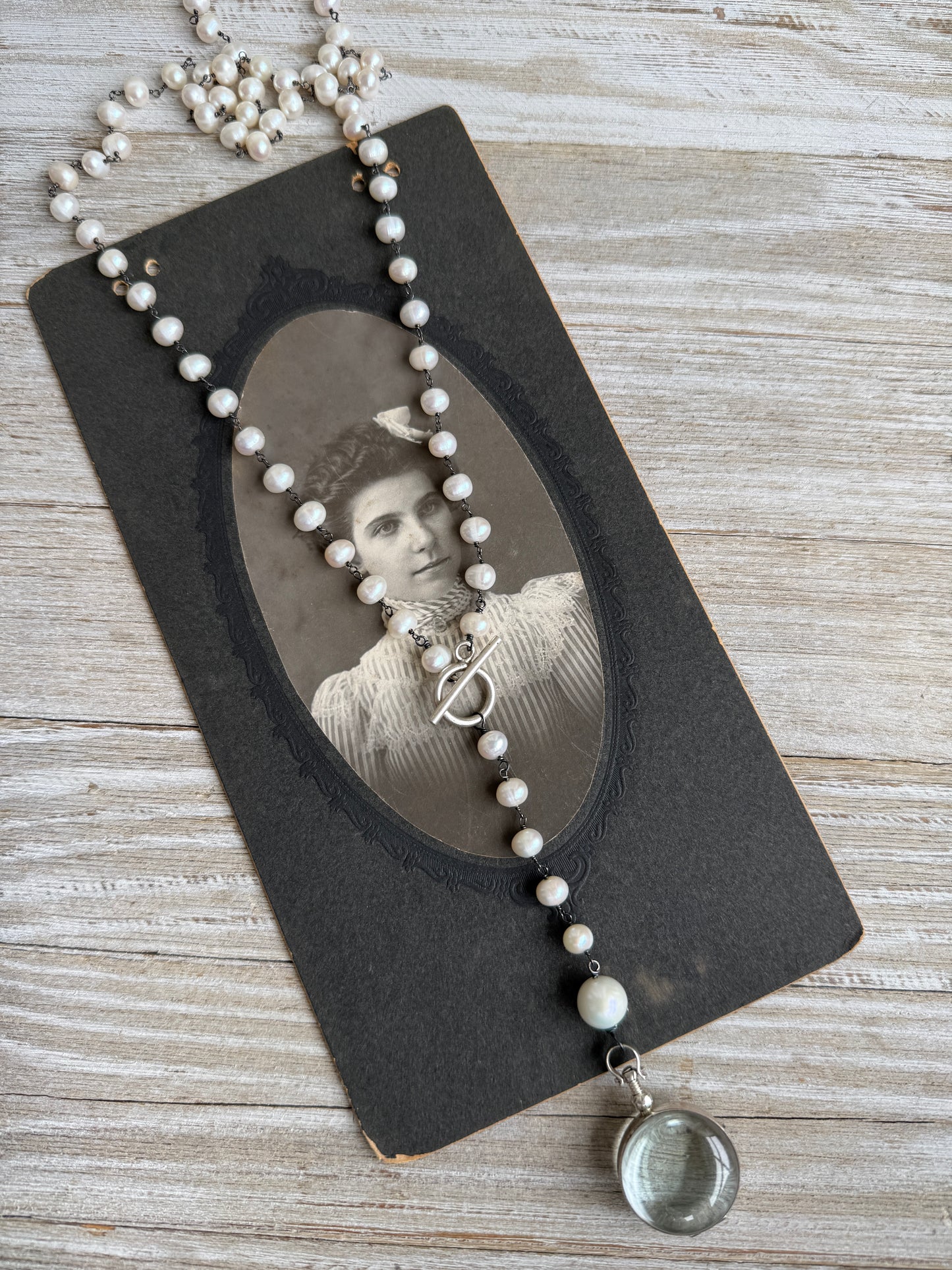 Pearl and sterling locket Y necklace.