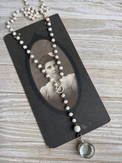 Pearl and sterling locket Y necklace.