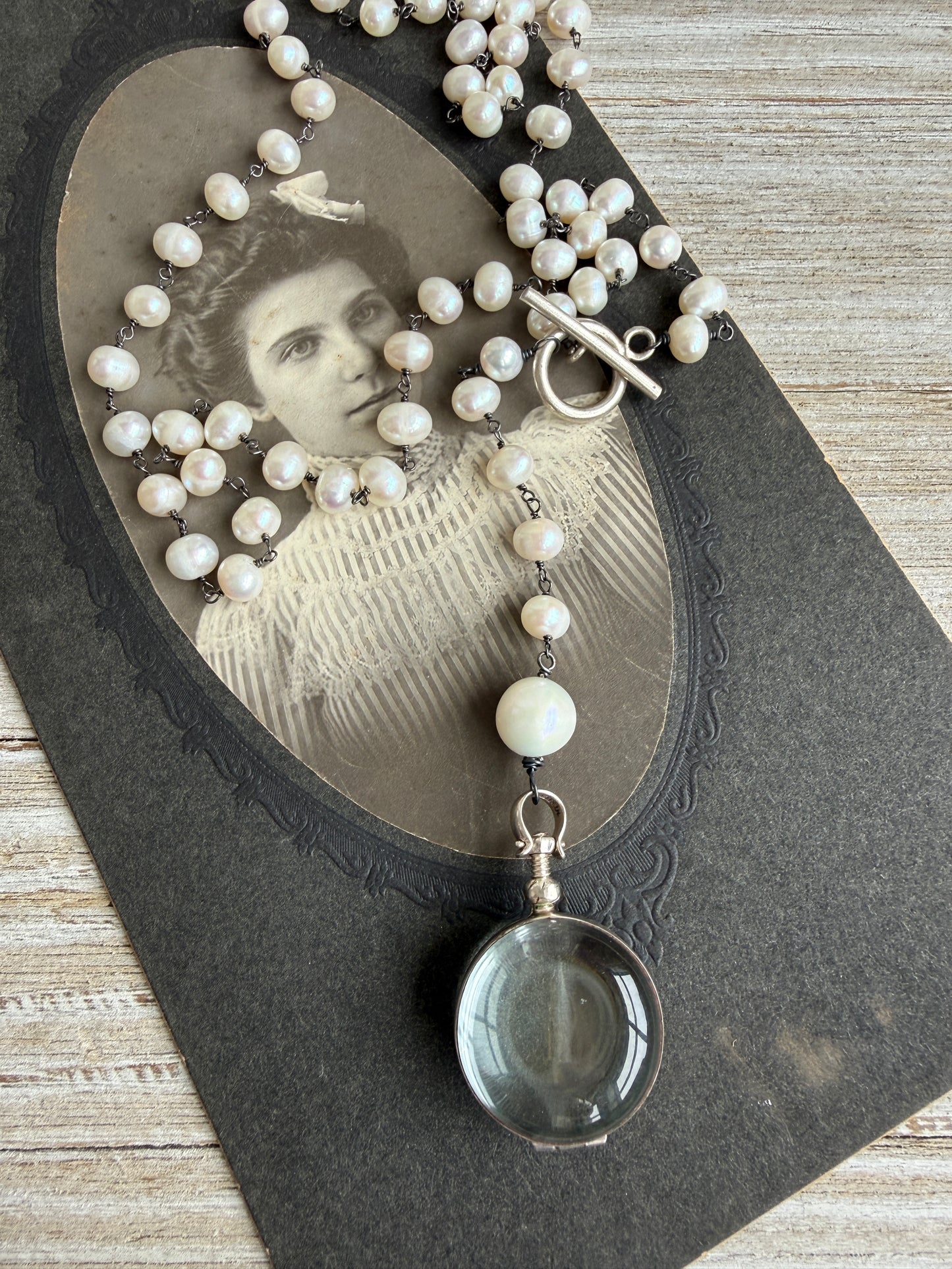 Pearl and sterling locket Y necklace.