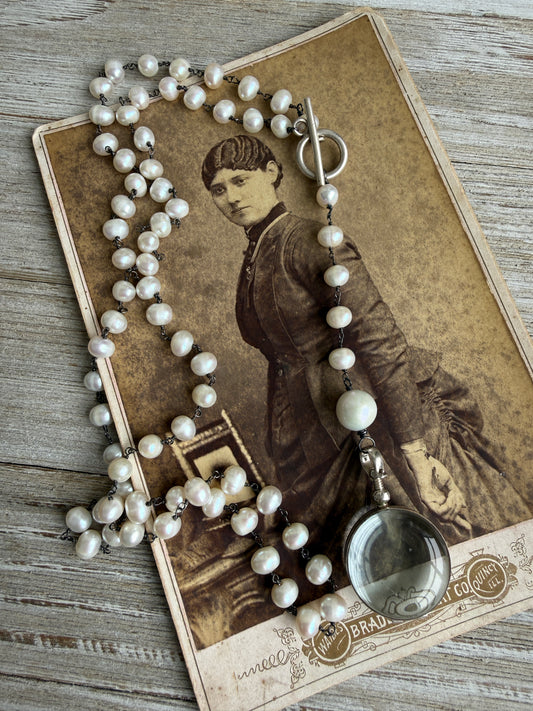 Pearl and sterling locket Y necklace.