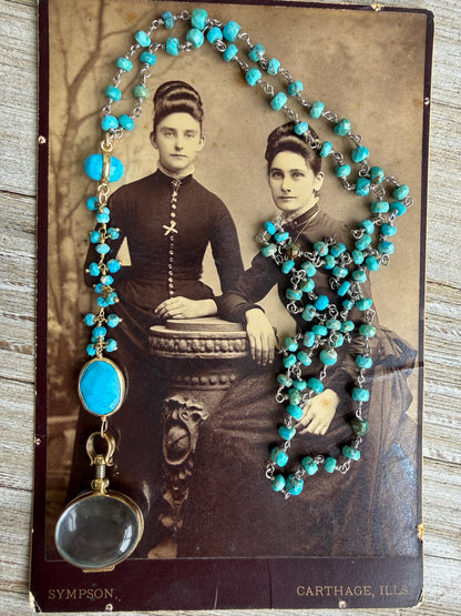 Turquoise rosary style chain with turquoise and gold accent pieces and brass locket necklace.
