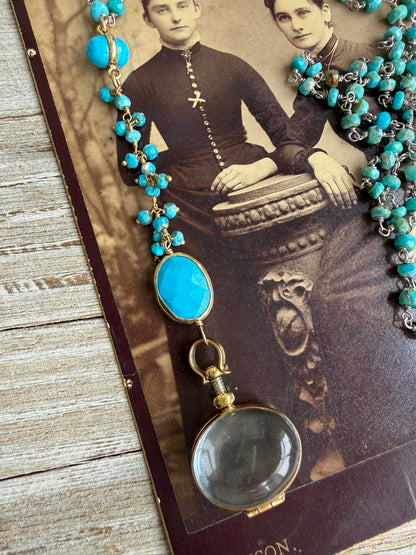 Turquoise rosary style chain with turquoise and gold accent pieces and brass locket necklace.