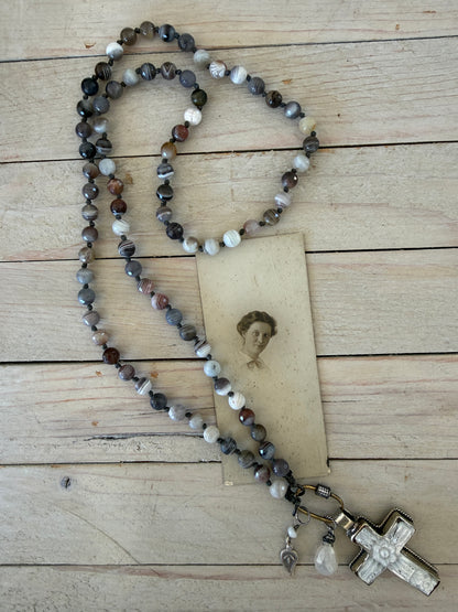 Carved Tibetan Mother of Pearl cross on knotted, faceted Botswana agates necklace.