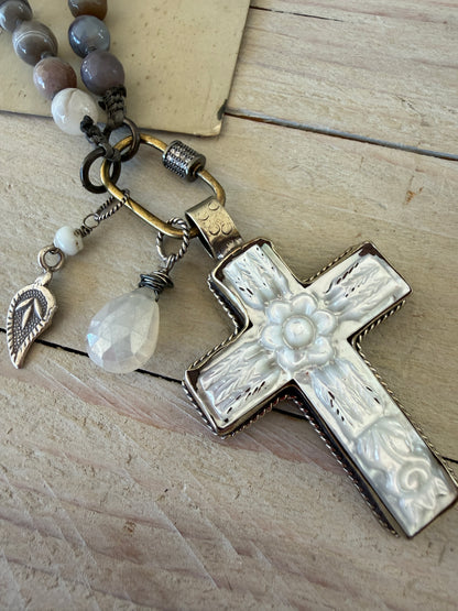Carved Tibetan Mother of Pearl cross on knotted, faceted Botswana agates necklace.