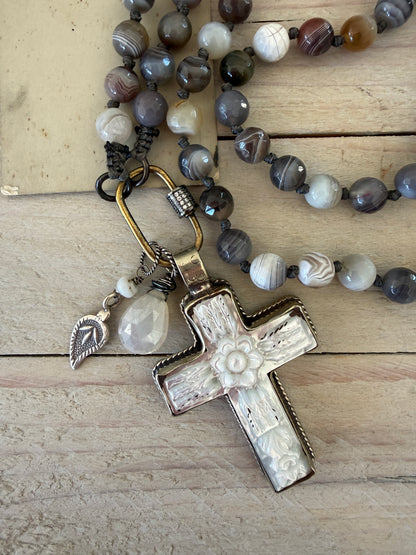 Carved Tibetan Mother of Pearl cross on knotted, faceted Botswana agates necklace.