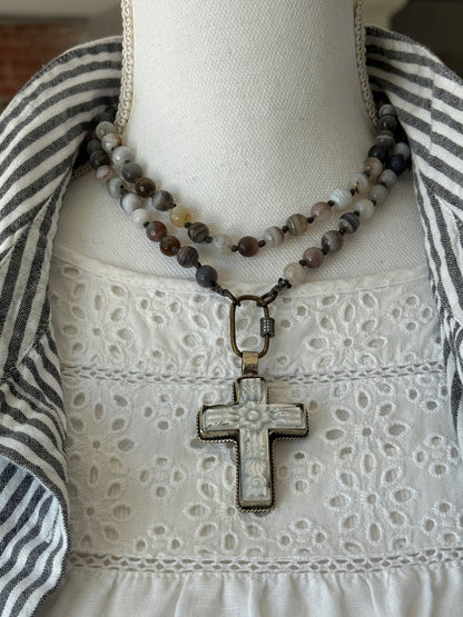 Carved Tibetan Mother of Pearl cross on knotted, faceted Botswana agates necklace.