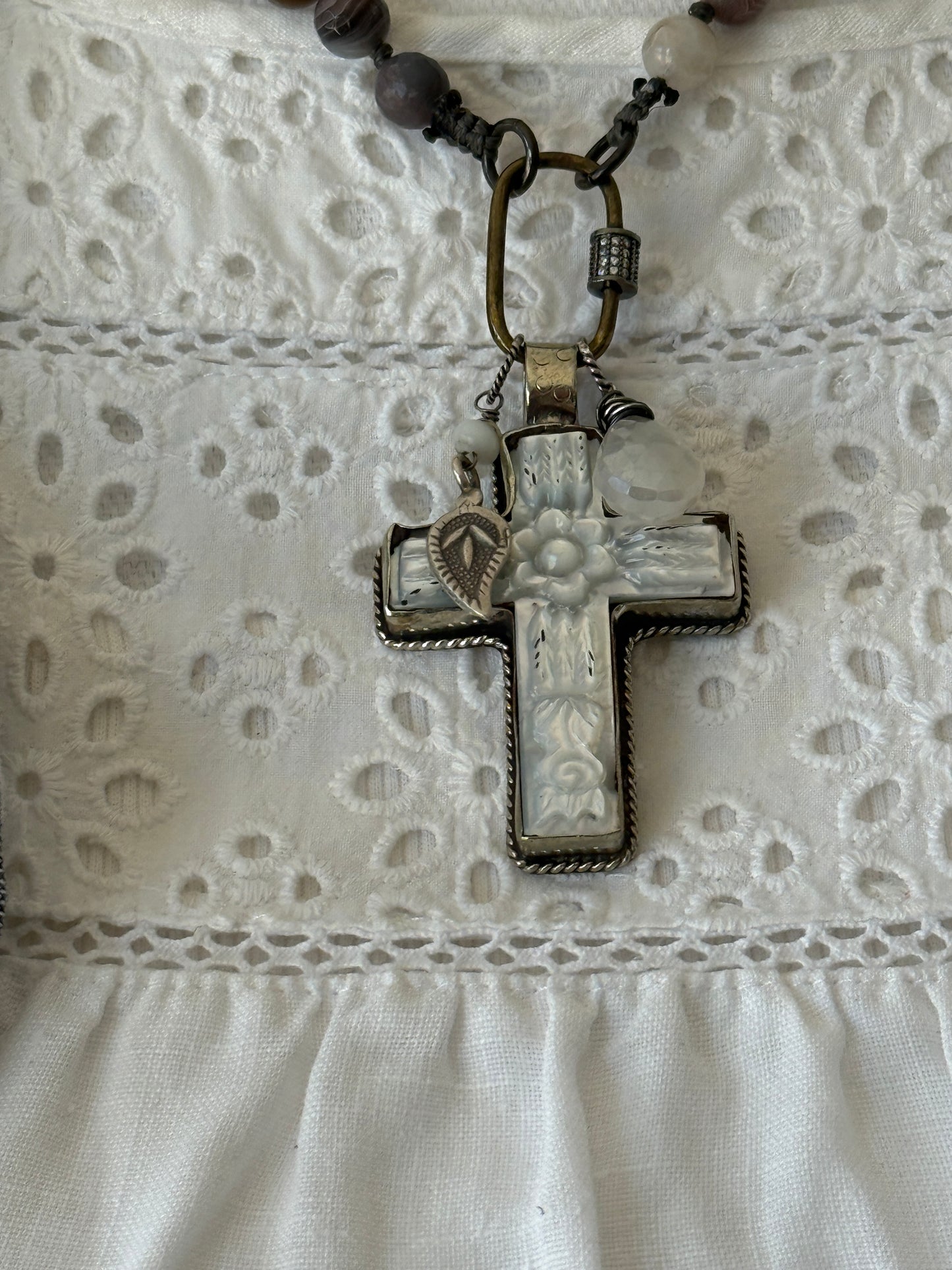 Carved Tibetan Mother of Pearl cross on knotted, faceted Botswana agates necklace.