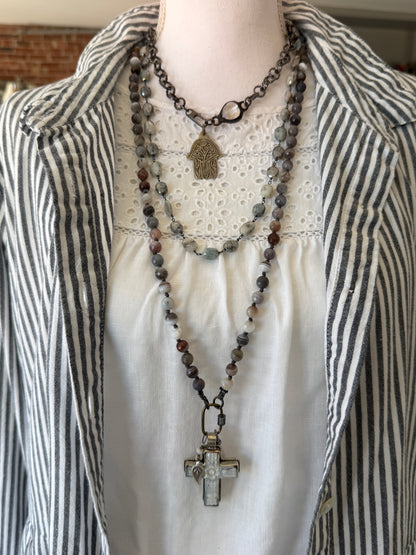 Carved Tibetan Mother of Pearl cross on knotted, faceted Botswana agates necklace.