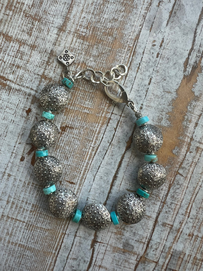 Stamped fine silver coins and turquoise bracelet. Adjustable 7-8”.