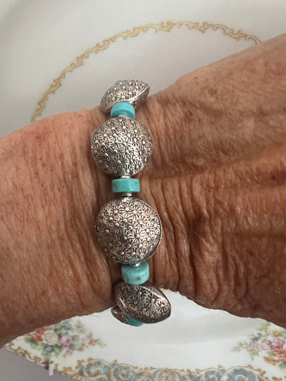 Stamped fine silver coins and turquoise bracelet. Adjustable 7-8”.