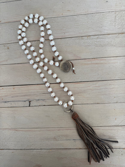 White pearls knotted on leather long necklace with removable tassel.