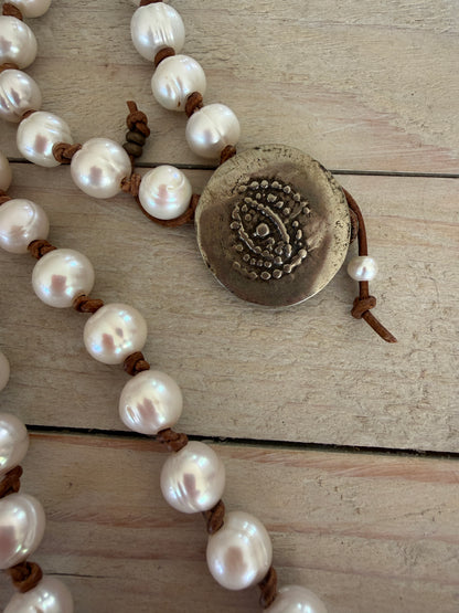 White pearls knotted on leather long necklace with removable tassel.