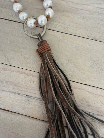White pearls knotted on leather long necklace with removable tassel.