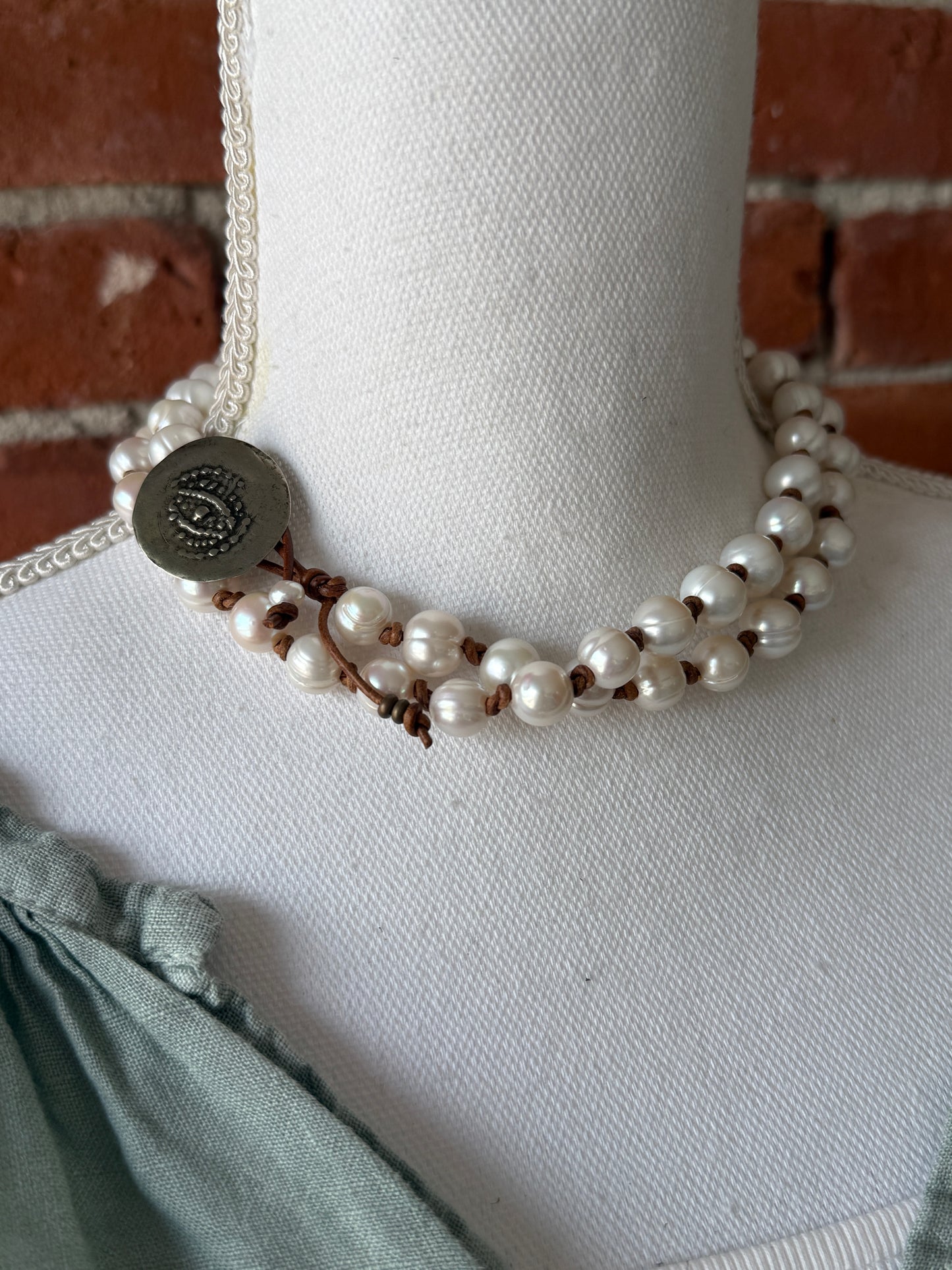 White pearls knotted on leather long necklace with removable tassel.