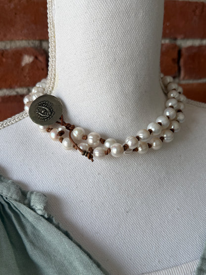 White pearls knotted on leather long necklace with removable tassel.