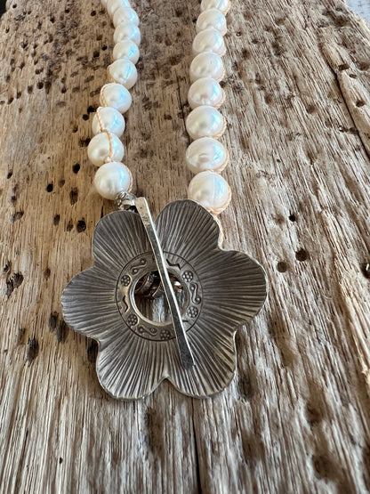 Fine silver flower on hand knotted pearls necklace. Front or side toggle