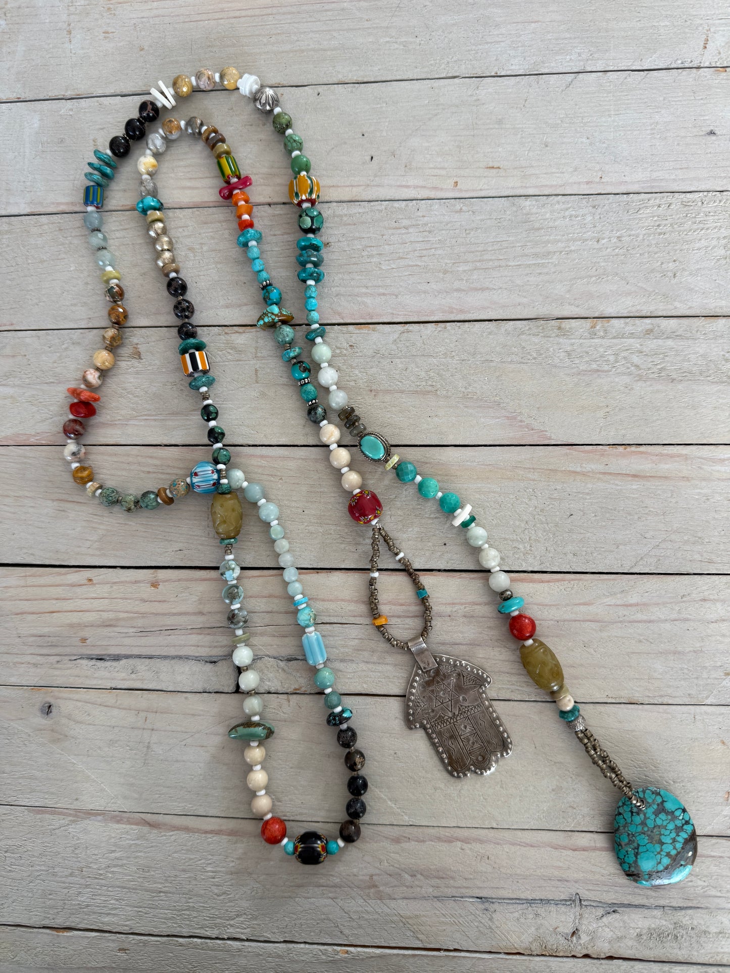 57” of turquoise Amazonite, Jasper, larimar, jade, riverstone, trade beads, Ethiopian silver, broom coral, and others lariat necklace with sterling hamsa and turquoise necklace.
