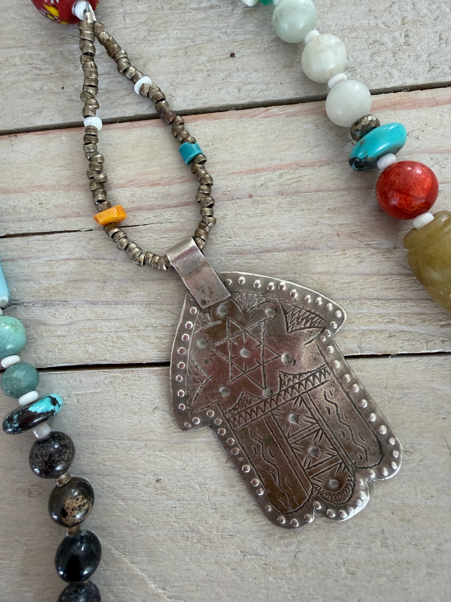 57” of turquoise Amazonite, Jasper, larimar, jade, riverstone, trade beads, Ethiopian silver, broom coral, and others lariat necklace with sterling hamsa and turquoise necklace.