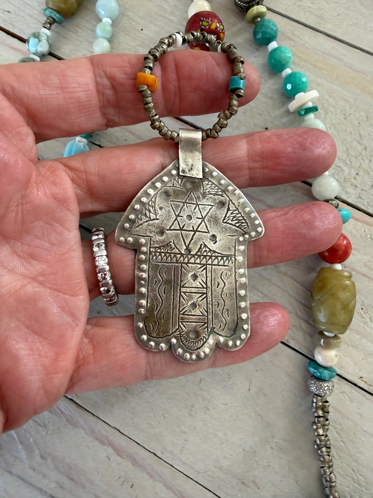 57” of turquoise Amazonite, Jasper, larimar, jade, riverstone, trade beads, Ethiopian silver, broom coral, and others lariat necklace with sterling hamsa and turquoise necklace.