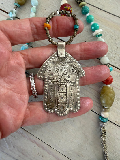 57” of turquoise Amazonite, Jasper, larimar, jade, riverstone, trade beads, Ethiopian silver, broom coral, and others lariat necklace with sterling hamsa and turquoise necklace.