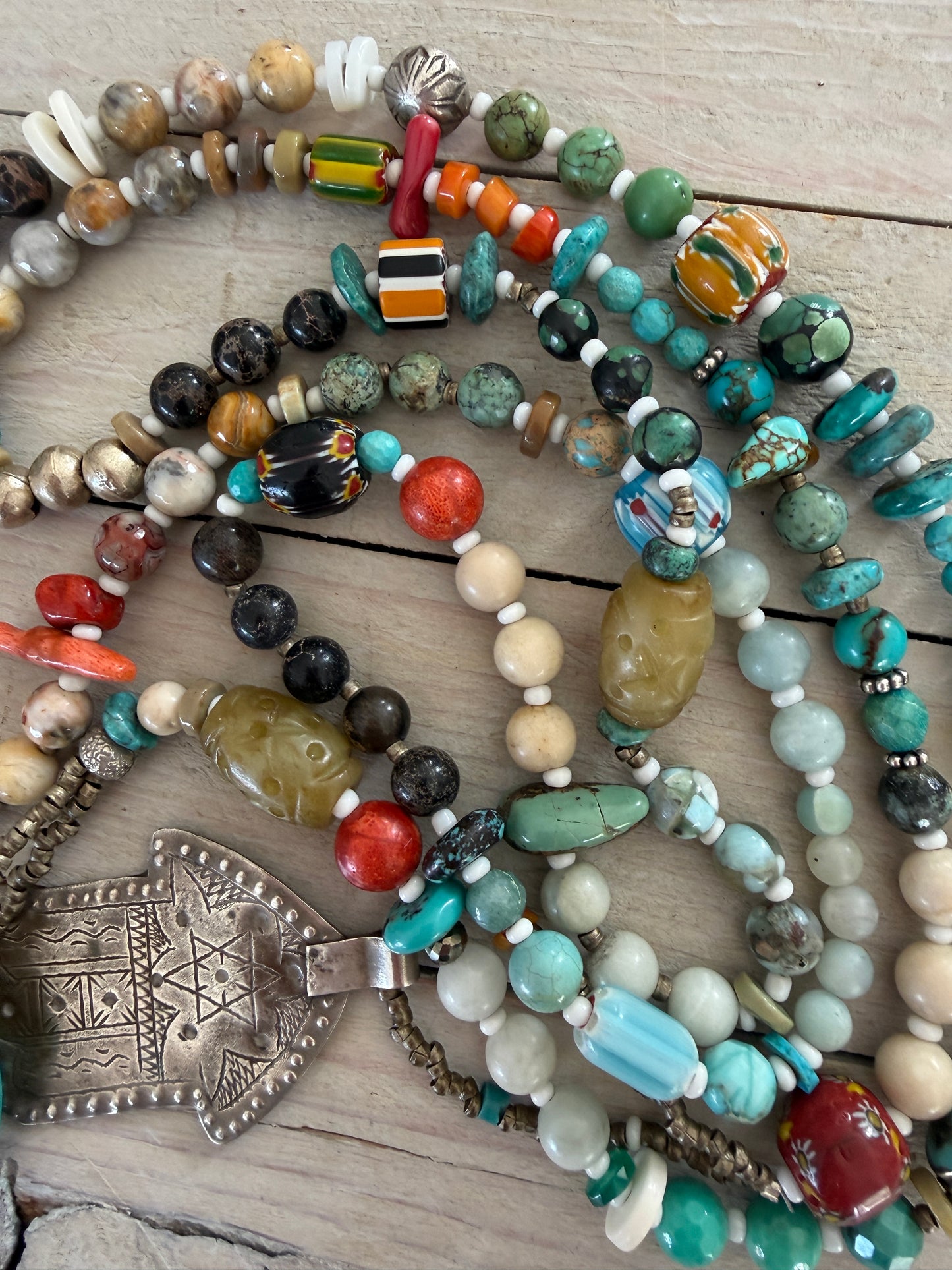 57” of turquoise Amazonite, Jasper, larimar, jade, riverstone, trade beads, Ethiopian silver, broom coral, and others lariat necklace with sterling hamsa and turquoise necklace.