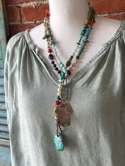 57” of turquoise Amazonite, Jasper, larimar, jade, riverstone, trade beads, Ethiopian silver, broom coral, and others lariat necklace with sterling hamsa and turquoise necklace.