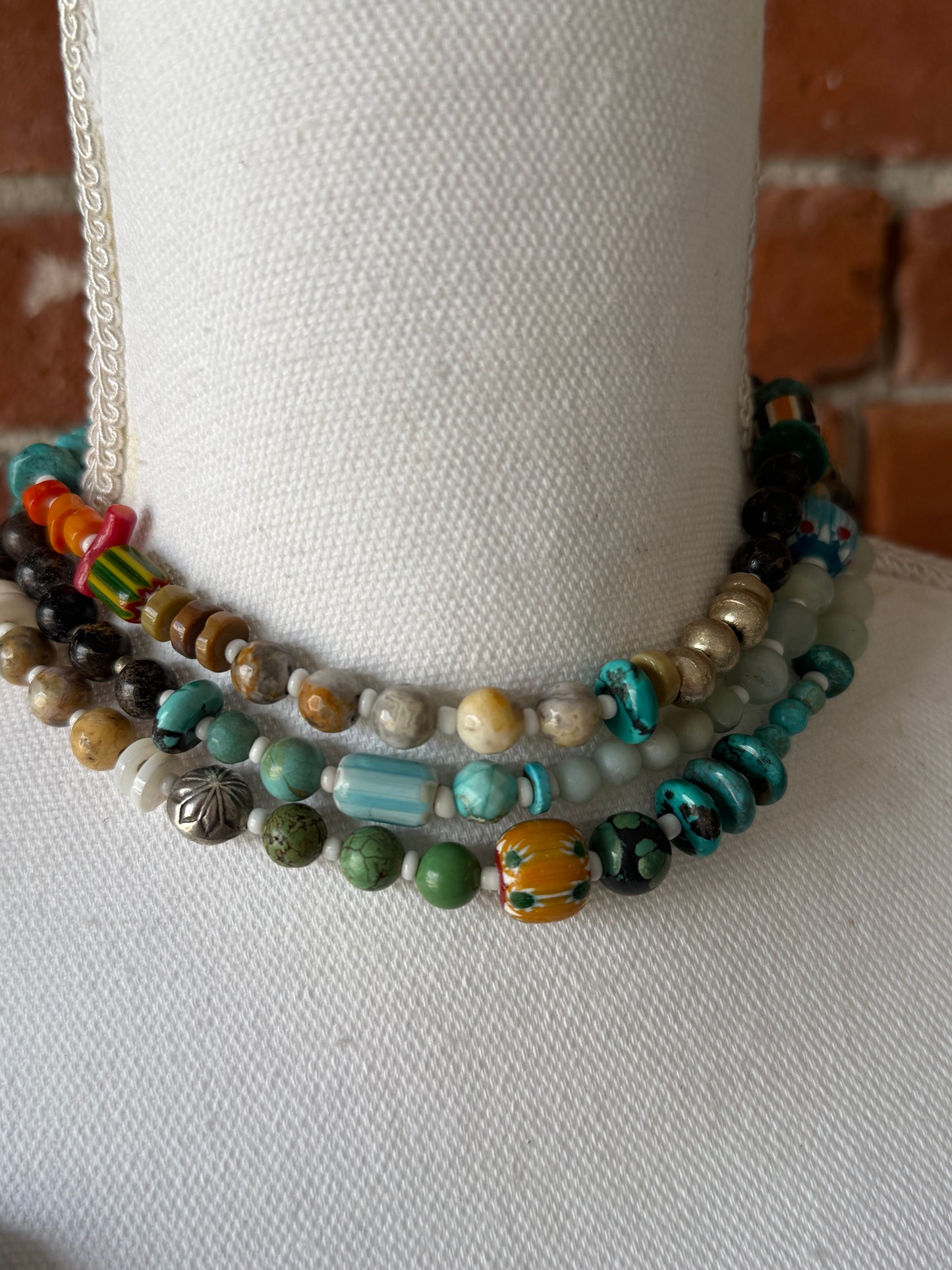 57” of turquoise Amazonite, Jasper, larimar, jade, riverstone, trade beads, Ethiopian silver, broom coral, and others lariat necklace with sterling hamsa and turquoise necklace.