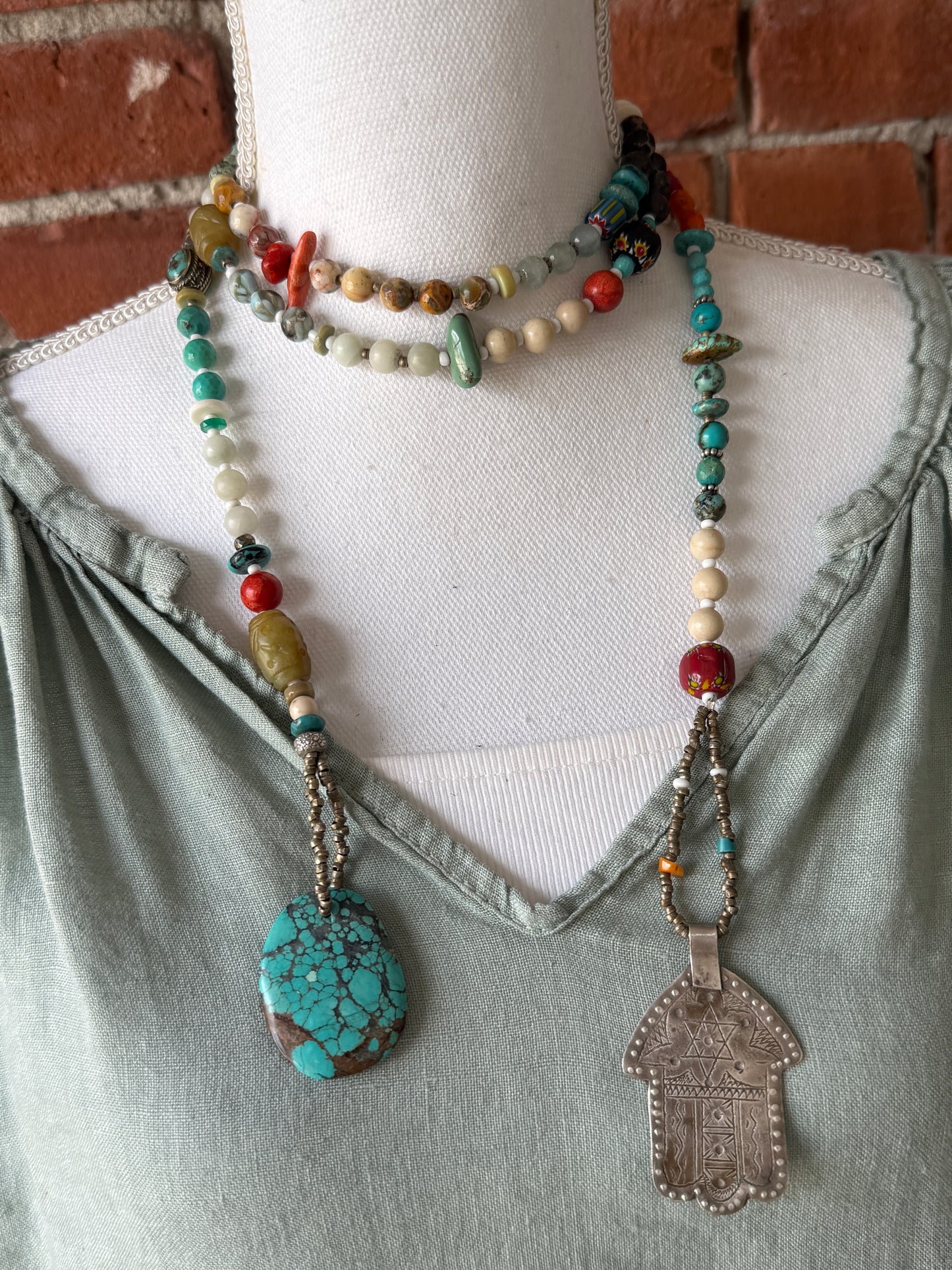57” of turquoise Amazonite, Jasper, larimar, jade, riverstone, trade beads, Ethiopian silver, broom coral, and others lariat necklace with sterling hamsa and turquoise necklace.