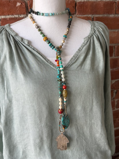 57” of turquoise Amazonite, Jasper, larimar, jade, riverstone, trade beads, Ethiopian silver, broom coral, and others lariat necklace with sterling hamsa and turquoise necklace.