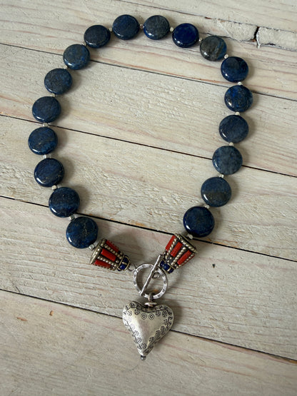 Lapis lazuli coins with Tibetan lapis and coral inlay focal beads necklace. Fine silver toggle clasp and heart. 18”