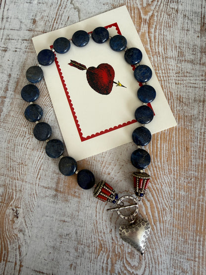 Lapis lazuli coins with Tibetan lapis and coral inlay focal beads necklace. Fine silver toggle clasp and heart. 18”