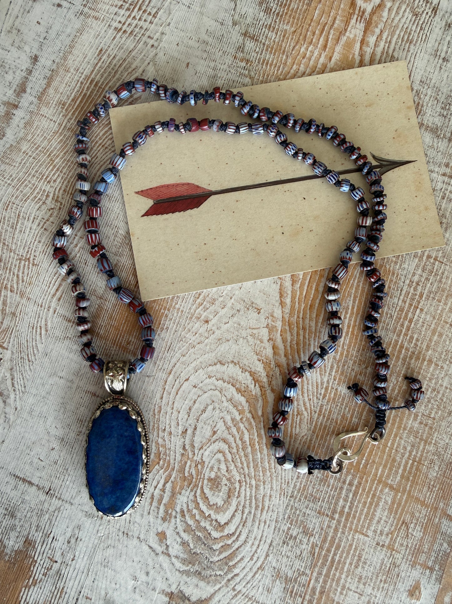 Lapis lazuli pendant (Tibet) with hand knotted blue terracotta chevron beads long necklace.