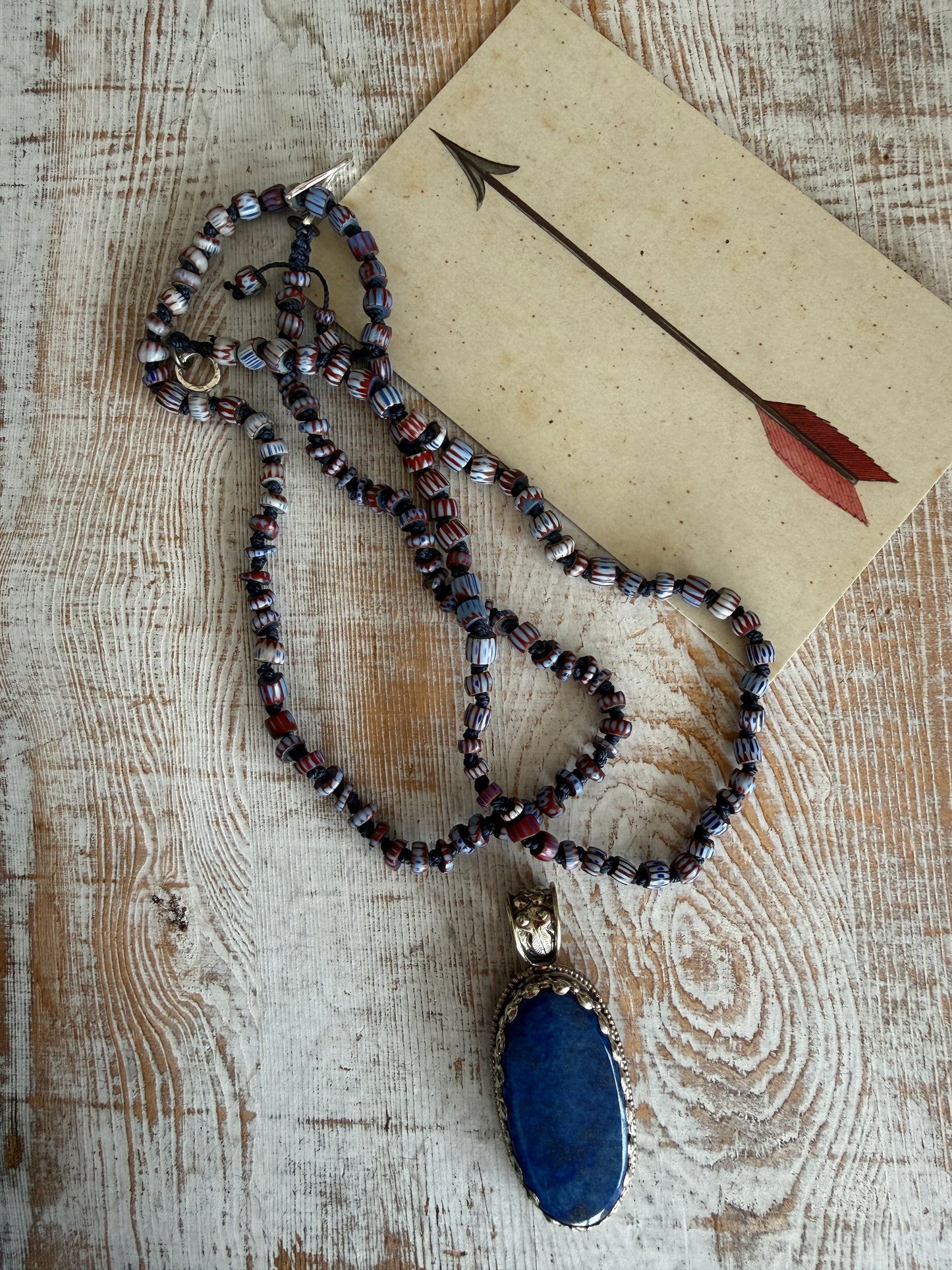 Lapis lazuli pendant (Tibet) with hand knotted blue terracotta chevron beads long necklace.